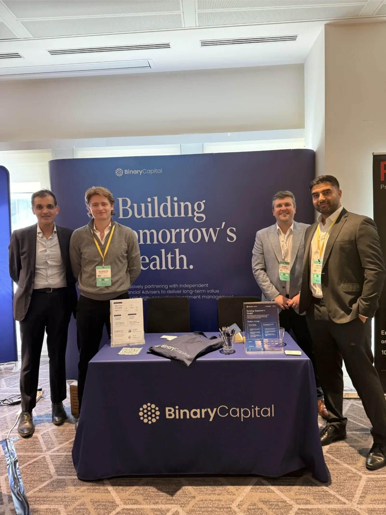 The Binary Capital team at an adviser conference stand